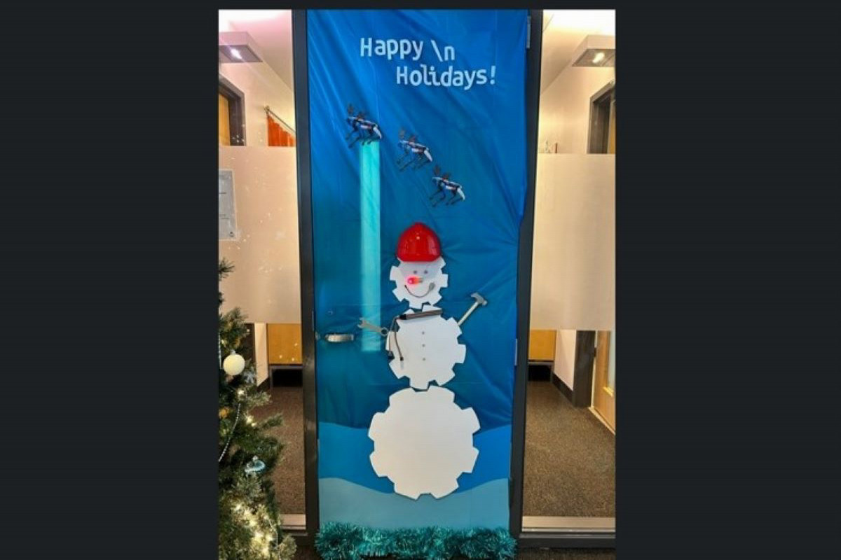 2024 Door Decorating Contest Winner - snowman made out of gears wearing a hard hat.