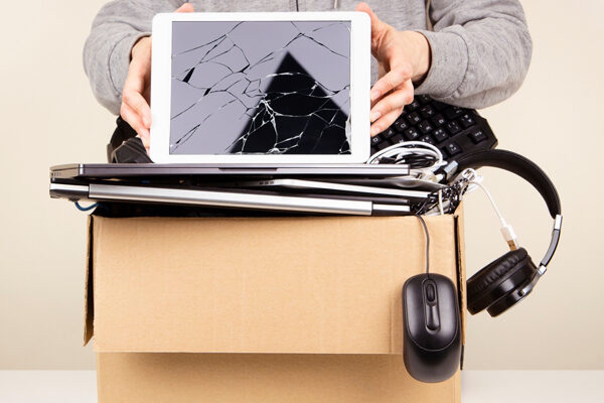Person placing e-waste into a cardboard box