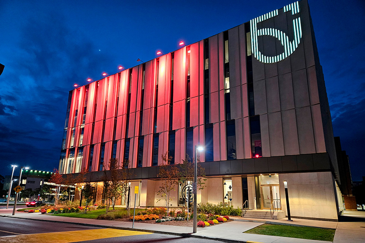 Shawenjigewining Hall lit up orange in recognition and support of Orange Shirt Day and National Day for Truth and Reconciliation.