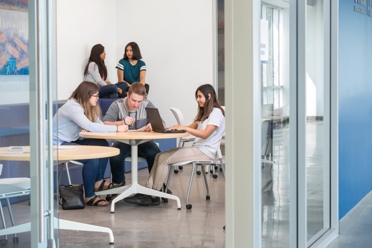 A group of students sitting around a table.