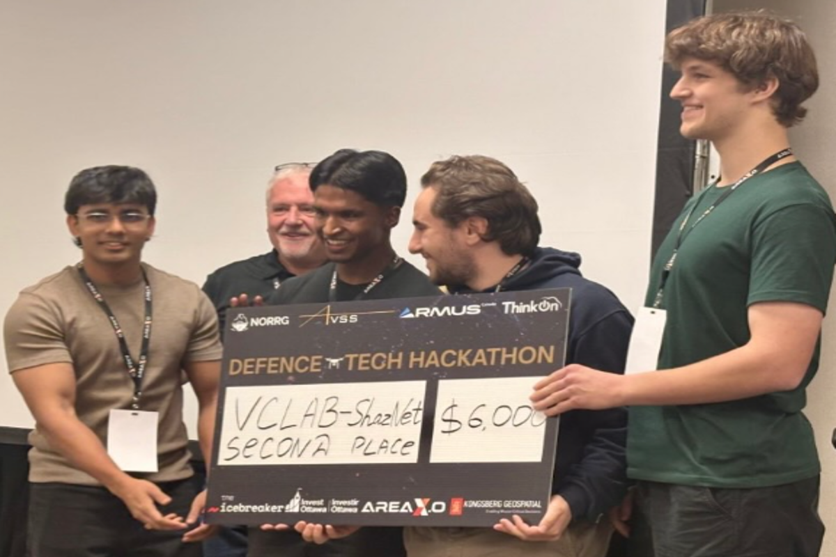 ShazNet team members accept prize at Defense Tech Hackathon
