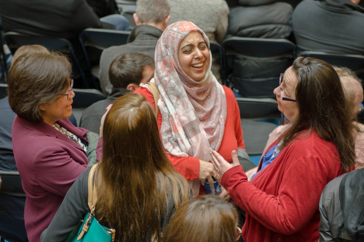 Ontario Tech colleagues laugh and chat at the Celebrate Teaching! Awards ceremony.