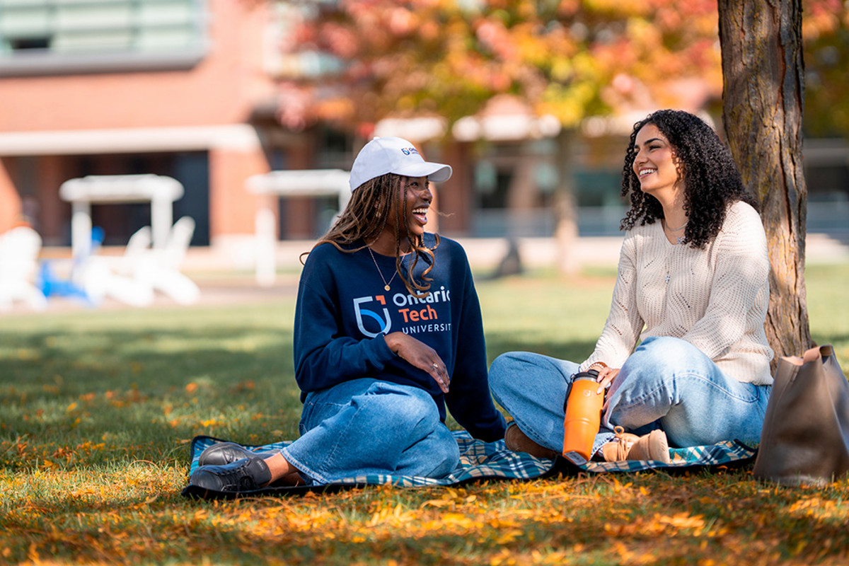 Two students having a cheerful conversation on Polonsky Commons